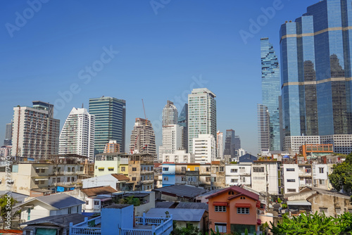 Panoramic city skyline of Bangkok with slums on the foreground. Contrasts of a rapidly developing city and country economy
