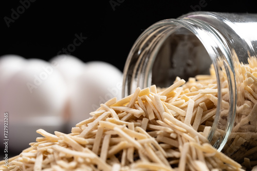 Turkish Style Noodle Also Known as Eriste in Turkish Spilled on Table. Eggs and Flour on Background. photo