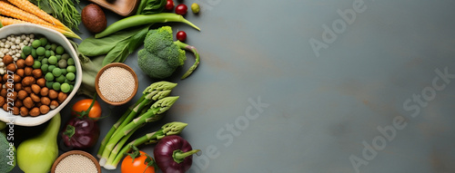 Wide view from above banner image of Vegetarian Day food banner with different types of vegetables and fruit items in a manner on gray color wooden table mockup