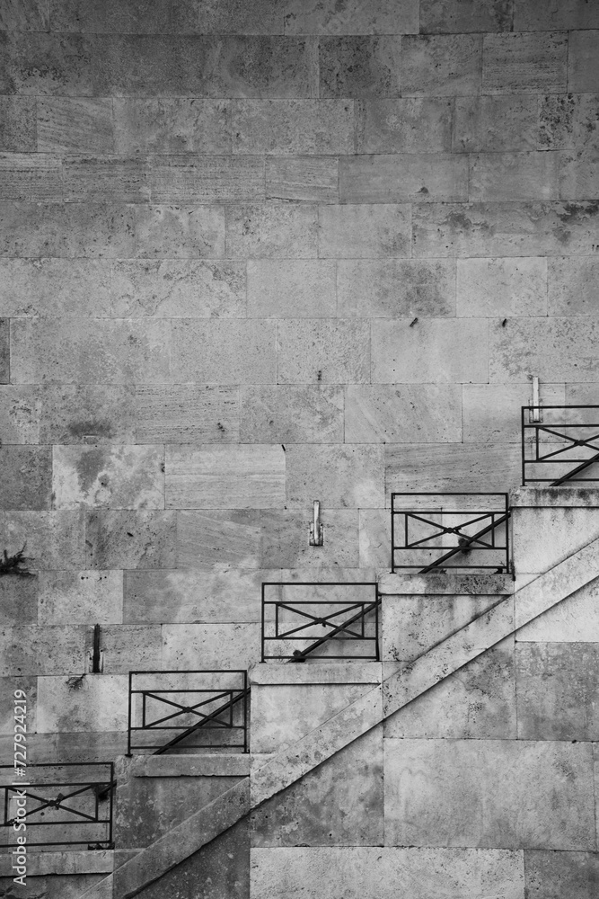 Fototapeta premium staircase of rod iron design hand rail on old weathered concrete block wall blank space for type travel background backdrop from Palermo Sicily italy ancient building square rod iron metal design 