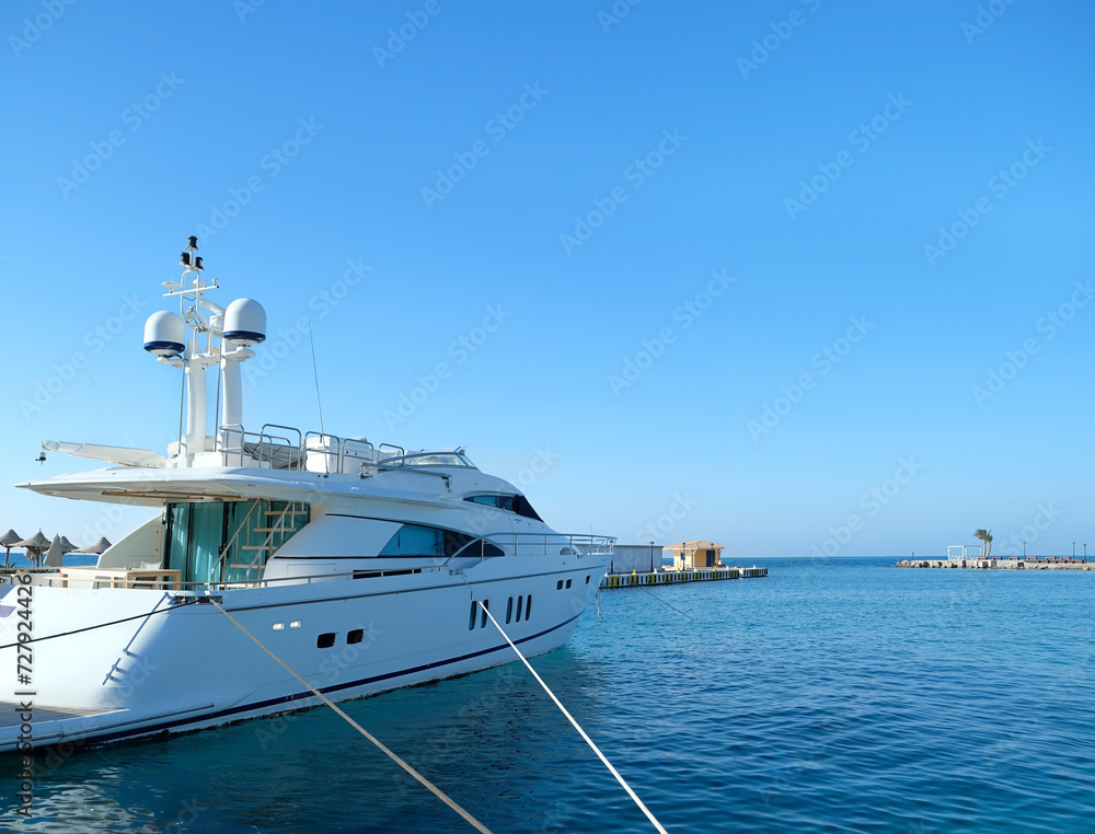 white private motor yacht in seaport, blue water and sky natural background. Exotic tourism, Marine tropical Vacation. Adventure, travel recreation concept. template for design