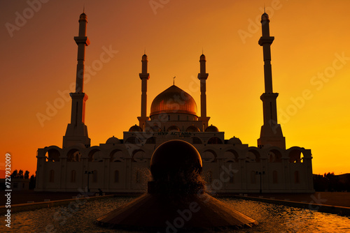 Silhouette of a mosque in Astana against clear sunset sky