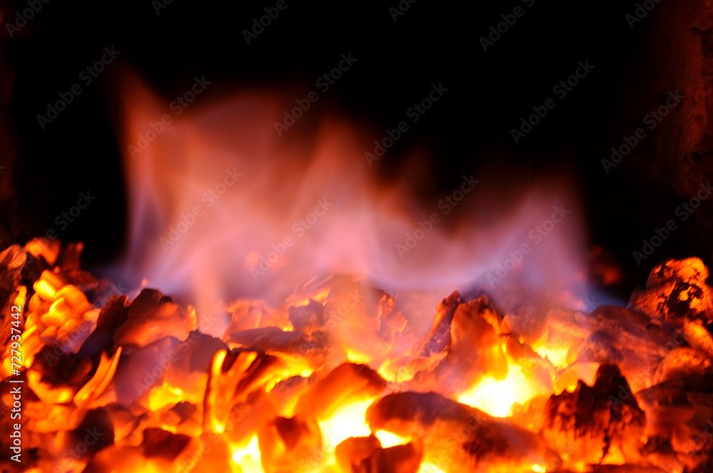 Hot red charcoal in the furnace firebox.