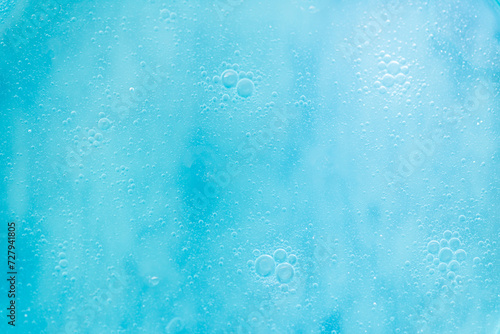 Air bubbles in the water background.Abstract oxygen bubbles in the sea.Water bubbles isolate on blue background.Sunlight underwater with bubbles rising to water surface in the sea