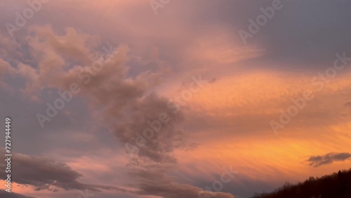 Beautiful sunset sky with clouds over Carpathian mountain forest