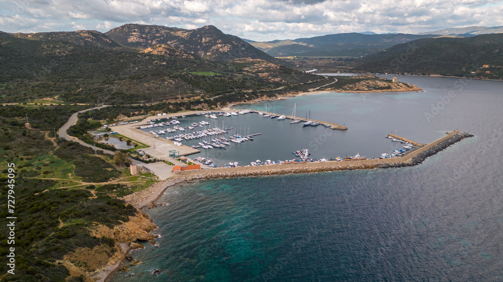 Aerial drone shots of the port of Teulada with Isola Rossa and Tramatzu beach with white sand and crystal clear water.