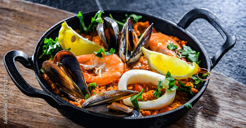 Seafood paella served in a cast iron pan photo
