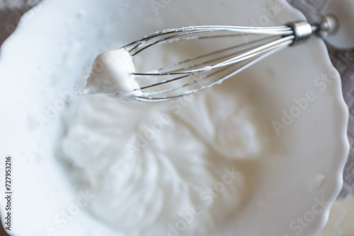 Whippening egg whites mixer whisk. Waves of white cream view from whipped whites for publication, poster, calendar, post, screensaver, wallpaper, postcard, banner, website. High quality photo