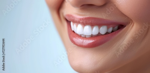 close-up of a women smilingon a blue background with space for text , Teeth whitening. Dental clinic patient. Stomatology concept