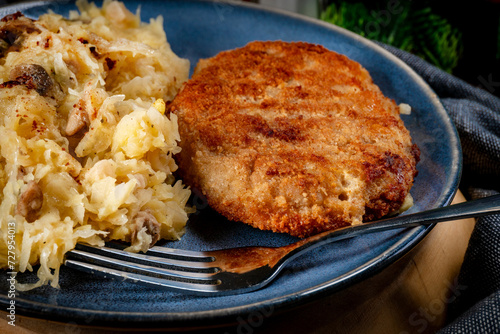 Minced meat cutlet with boiled sauerkraut.
