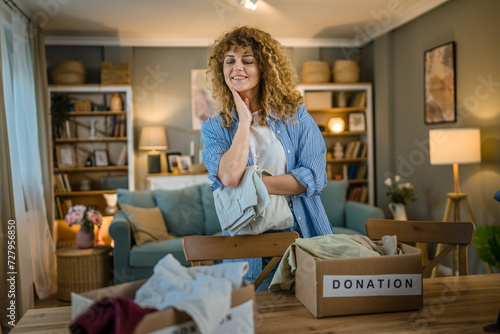 One young adult woman prepare wardrobe clothes for charity donation