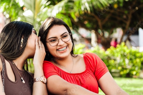 Foto Two best hispanic women friends having fun outside.
