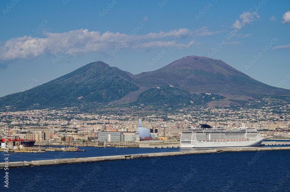 Mega modern cruise ship cruiseship liner Preziosa in port of Naples Napoli, Italy with Vesuv volcano panorama for Mediterranean summer cruising