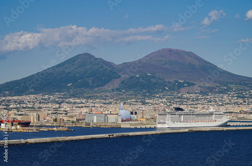 Mega modern cruise ship cruiseship liner Preziosa in port of Naples Napoli, Italy with Vesuv volcano panorama for Mediterranean summer cruising photo