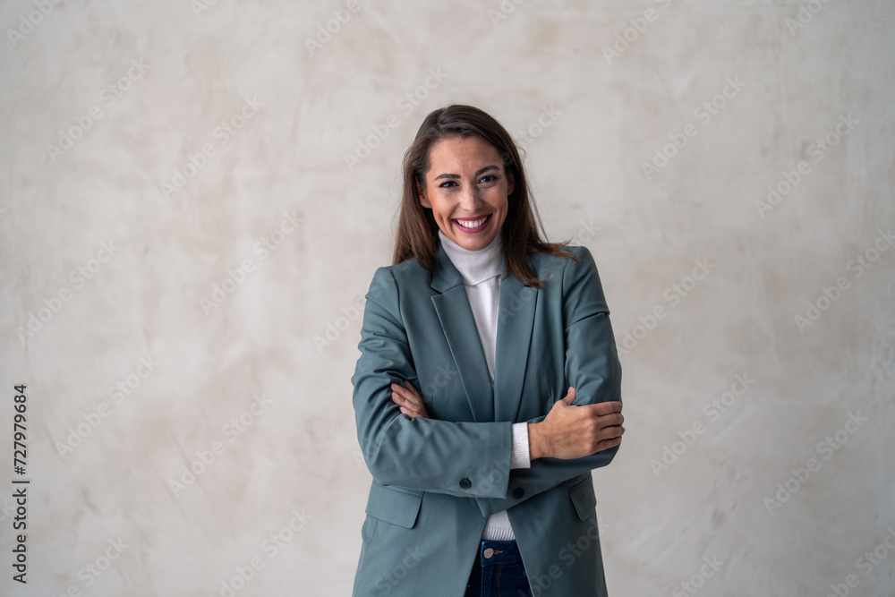 Happy young smiling confident professional business woman wearing suit, pretty stylish female executive looking at camera, standing arms crossed isolated at gray background, portrait. Happy young smiling confident professional business woman wearing suit, pretty stylish female executive looking at camera, standing arms crossed isolated at gray background, portrait.