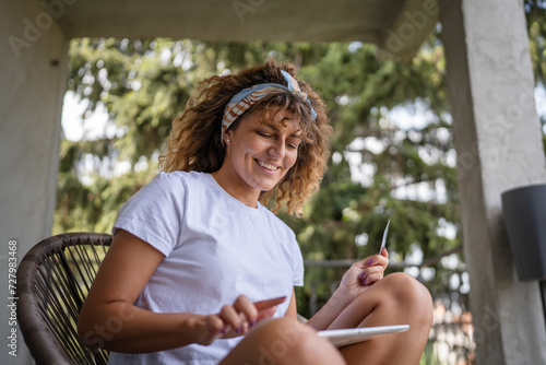 One woman shopping online hold credit card and digital tablet