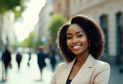 Afro woman smiles in a business suit on a street