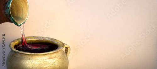 Tableau sur toile A hand holds a clay jar and pours water