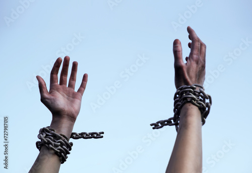 Praying man with shackled hands photo