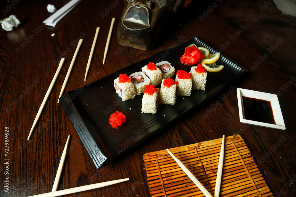 Black Plate With Sushi and Chopsticks Black Plate With Sushi and Chopsticks