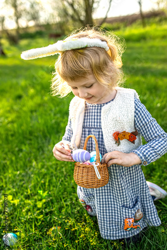 celebration of spring and Easter . young girl  filled with excitement  engages in challenge of an egg hunt.