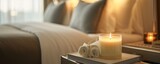  luxury travel-themed candle on a nightstand in a softly lit bedroom, for a marketing campaign or website for high-end hotels or travel agencies promoting relaxing and upscale accommodation experience