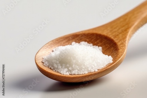 Crystals of large sea salt in a wooden spoon