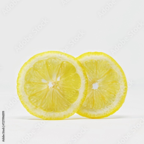 Two lemon slices next to each other on a white background