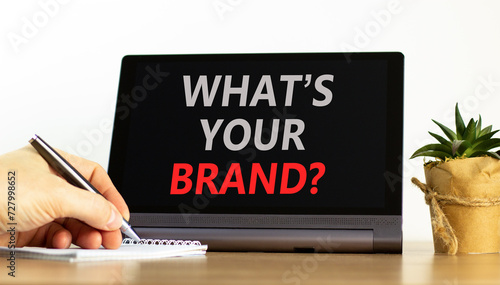 Branding what is your brand symbol. Concept words What is your brand on beautiful tablet screen. Beautiful white background. Businessman hand. Business branding what is your brand concept. Copy space.