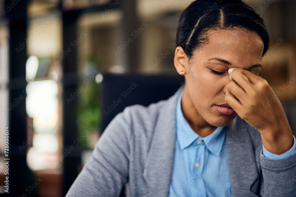 Close-up of a tired-looking woman who rubs her eyes with her hand and has a headache. Close-up of a tired-looking woman who rubs her eyes with her hand and has a headache.