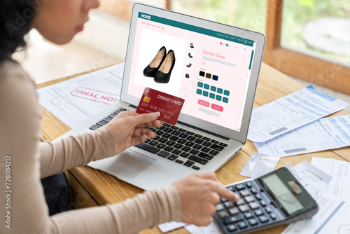 Woman shopping online on internet marketplace browsing for sale items for modern lifestyle and use credit card for online payment from wallet protected by crucial cyber security software