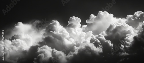 Ethereal Monochrome: White Clouds Drift Across the Dark Sky in a Stunning Display of Monochrome Beauty