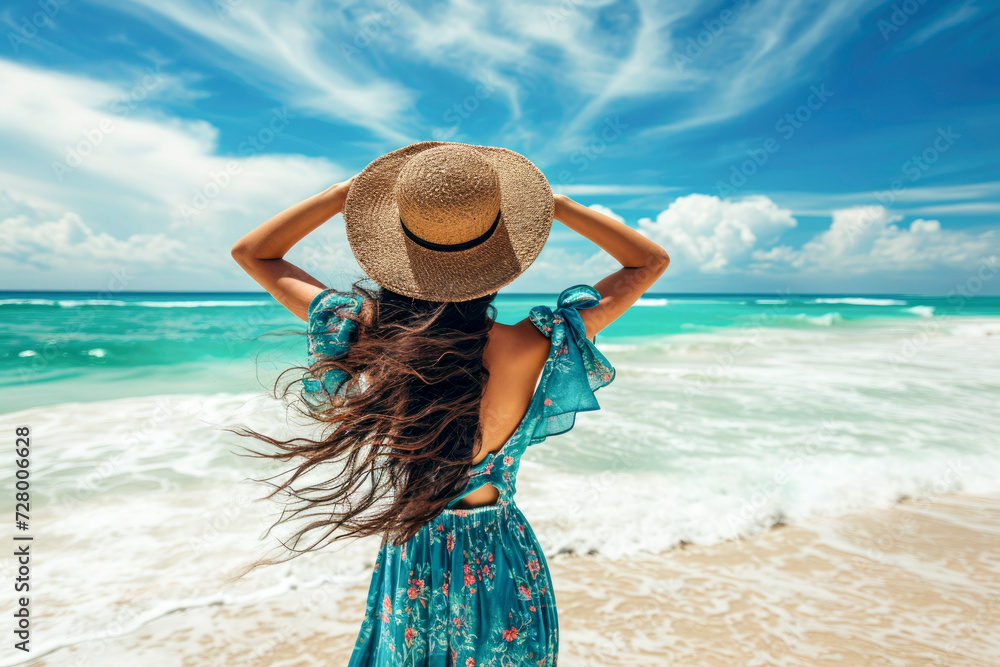 Summer beach vacation concept, Young woman with hat relaxing with her arms raised to her head enjoying looking view of beach ocean