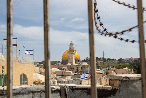 The Dome of the Rock and Bab al-Silsila Minaret, seen through barbed wire. Jewish and muslim conflict in the middle east