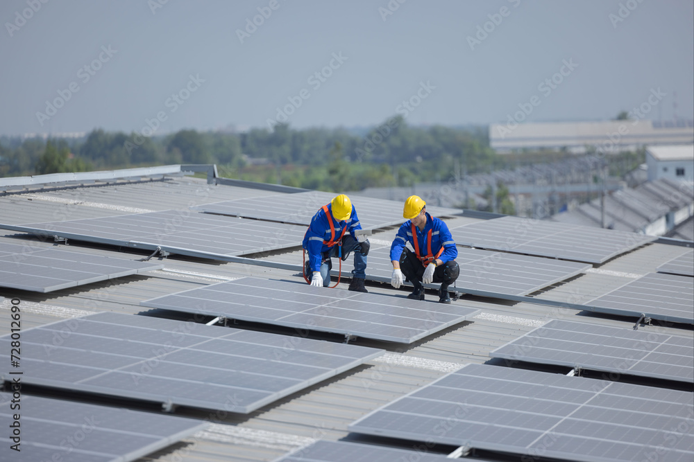 caucasian engineer checking on solar panel on the factory rooftop - obrazy, fototapety, plakaty 