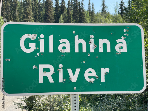 A shot-up sign Gilahina River, The McCarthy Road, Alaska
