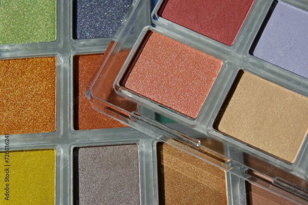 Fototapeta premium Make up palette set. Professional multicolor eyeshadow palette. Makeup. Professional multicolor eye shadow make-up palette, close-up. Various Colorful bright eye shadows.