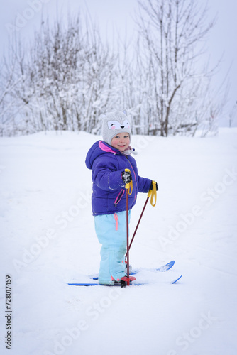Child skiing in mountains. Little toddler kid on skis for the first time. Winter sport for family.