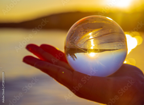 Fototapeta Naklejka Na Ścianę i Meble -  hand holding a glass sphere