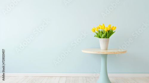 Elegant yellow tulips in a ceramic vase on a round table with a pastel backdrop
