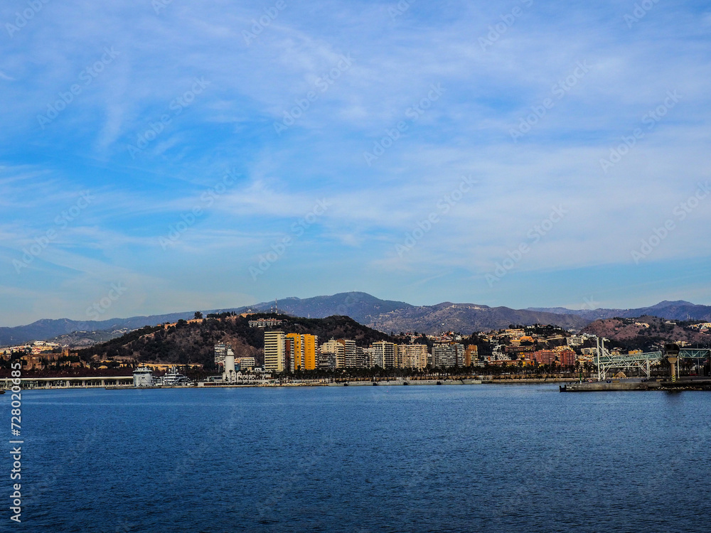 Scenic European Coastal Landscape with a View of Malaga and Boats under a Summer Sky Scenic European Coastal Landscape with a View of Malaga and Boats under a Summer Sky