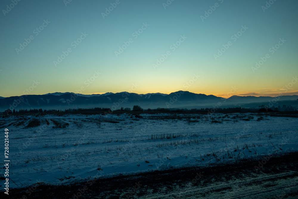 Sunset over mountains in winter season.