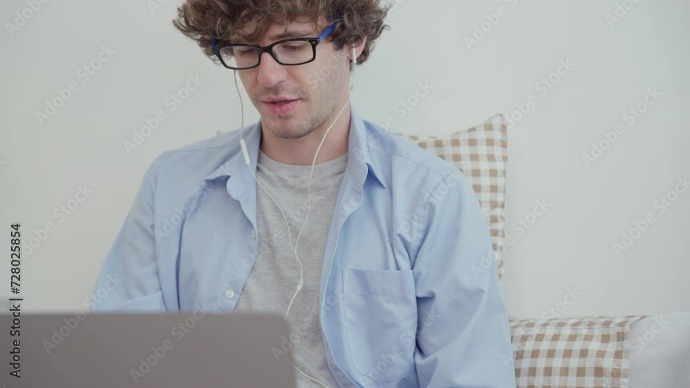 Man using earphone and laptop video conference with customer, team or colleagues. People working at home. Man using earphone and laptop video conference with customer, team or colleagues. People working at home.