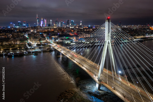 Swietokrzyski Bridge over the Vistula River with a panoramic view of the center of Warsaw at night. Poland