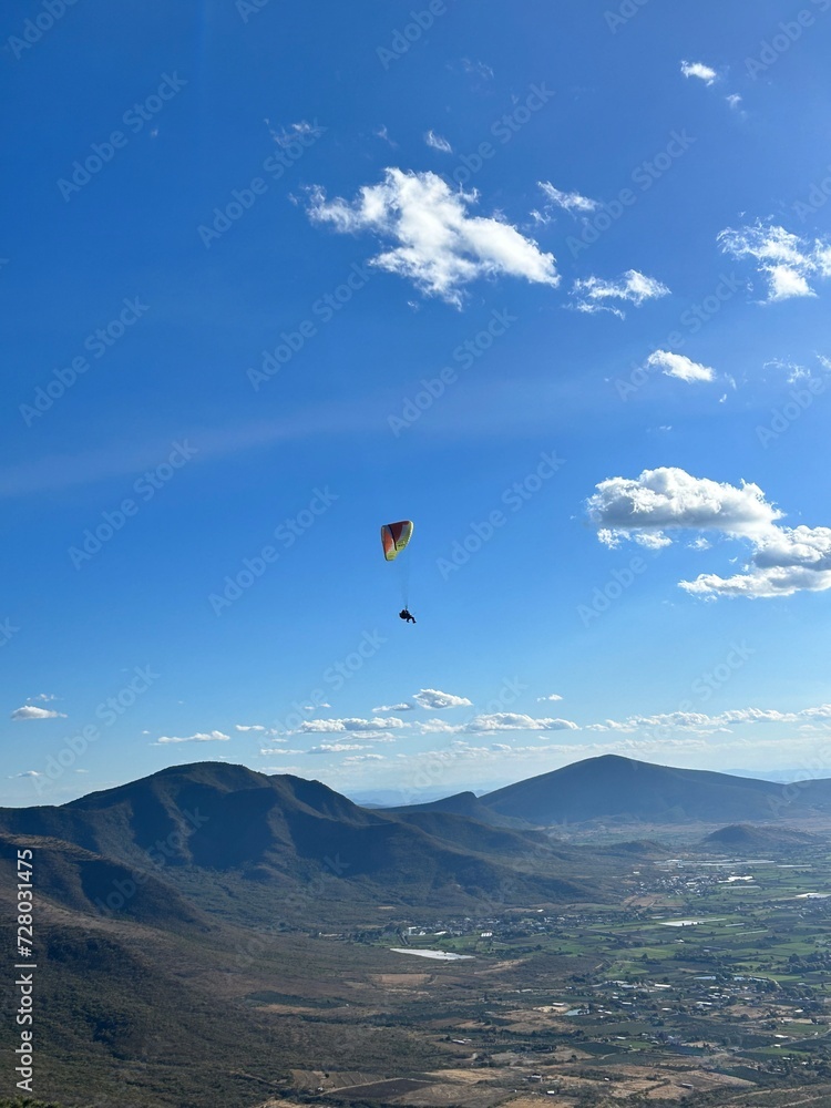 PHOTOGRAPH OF PARAGLIDERS FLYING FROM THE CHALCHIHUAPAN HILL, PUEBLA, MEXICO PHOTOGRAPH OF PARAGLIDERS FLYING FROM THE CHALCHIHUAPAN HILL, PUEBLA, MEXICO