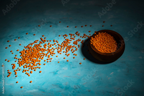 Fototapeta Naklejka Na Ścianę i Meble -  lentil cereals on blue background, pea family grains