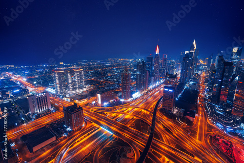 Aerial top view night cityscape of Dubai downtown skyscrapers with illuminated and highway. Business and financial modern district of city UAE photo