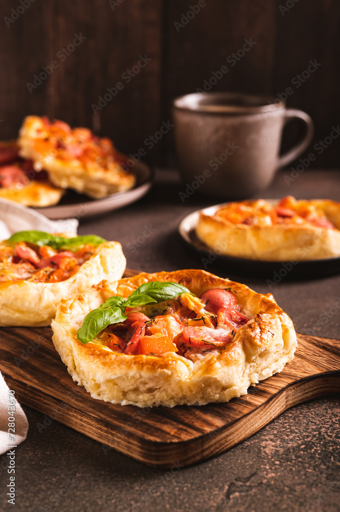 Chicago pizza pot pie with sausage, tomatoes and cheese on a board on the table vertical view Chicago pizza pot pie with sausage, tomatoes and cheese on a board on the table vertical view