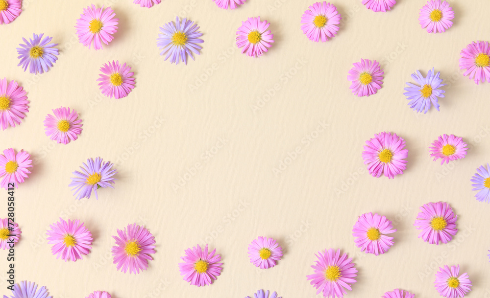 Floral stylish border frame of pink and purple flower aster on beige background. Spring and summer colorful flowers pattern. Flat lay, top view, mockup, copy space for text. Floral stylish border frame of pink and purple flower aster on beige background. Spring and summer colorful flowers pattern. Flat lay, top view, mockup, copy space for text.