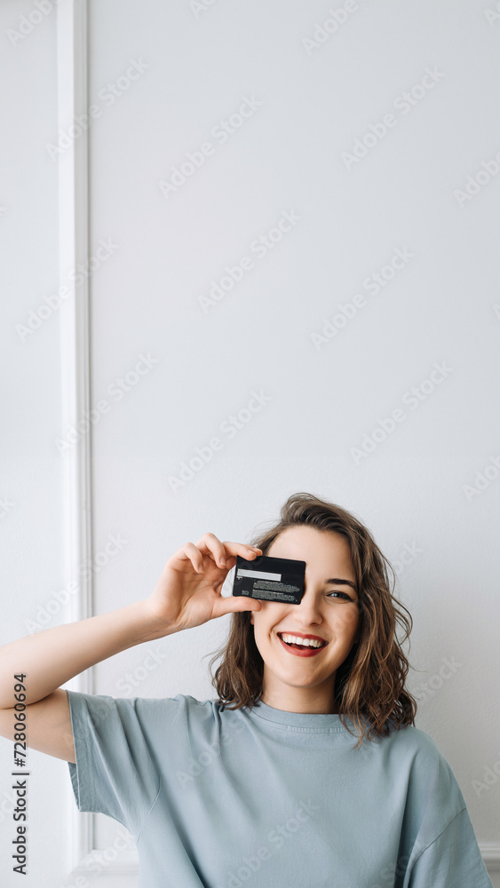 Joyful Woman Holding Credit Card, Shopping Online Happily. Happy Woman Playfully Peeking through Credit Card, Online Shopping. Cheerful Young Woman Playfully Posing with Credit Card, Online Shopping Joyful Woman Holding Credit Card, Shopping Online Happily. Happy Woman Playfully Peeking through Credit Card, Online Shopping. Cheerful Young Woman Playfully Posing with Credit Card, Online Shopping